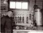 Harold Lincoln Thorley, motorman/mechanic, in the Midland Mine lamphouse. Wolf Safety lamps on wall.