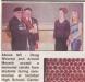 A photo from the paper showing Whorrall receiving a memorial candle from local students.
