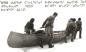 Inuit and one of the Fifth Thule Expedition men pulling a canoe to the ice edge