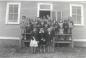 Elliston school students in front of an old one room school