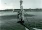 Dan McDougall standing on the spar of a swordfishing boat