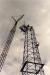 Massive crane lifts last few sections onto the top of the Discovery Derrick.