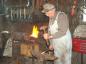 William Moreau working in his blacksmith shop.