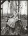 Unknown lady posing on top of a stump