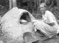 Bonnie Revell, the wife of a young mine doctor, bakes bread in a stone oven.