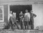 J. Burrill Outhouse with his employees standing in front of his boat shop