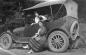 Posing with an automobile, circa 1920