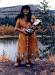 LSCFN Elder Agnes Charlie in traditional dress, carrying birchbark baby packer