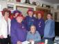 Norva Landry sitting with the Red Hat Society who were having a museum tour.