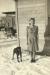 Elizabeth Heinrichs with dog Teddy at their Middle Island home; crank washing machine is in back